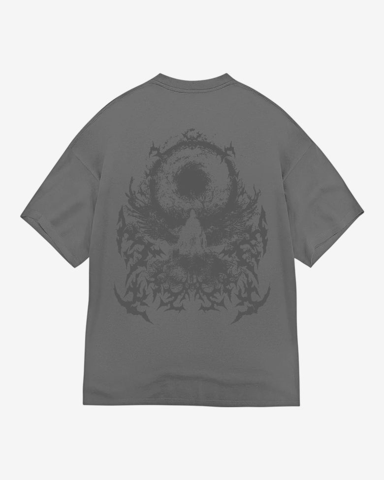 Oversize fit gray t-shirt with a graphic print of a skull and floral-like patterns on the back.