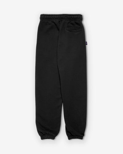 Back view: Fitted yoke and welt pockets on black terry trousers